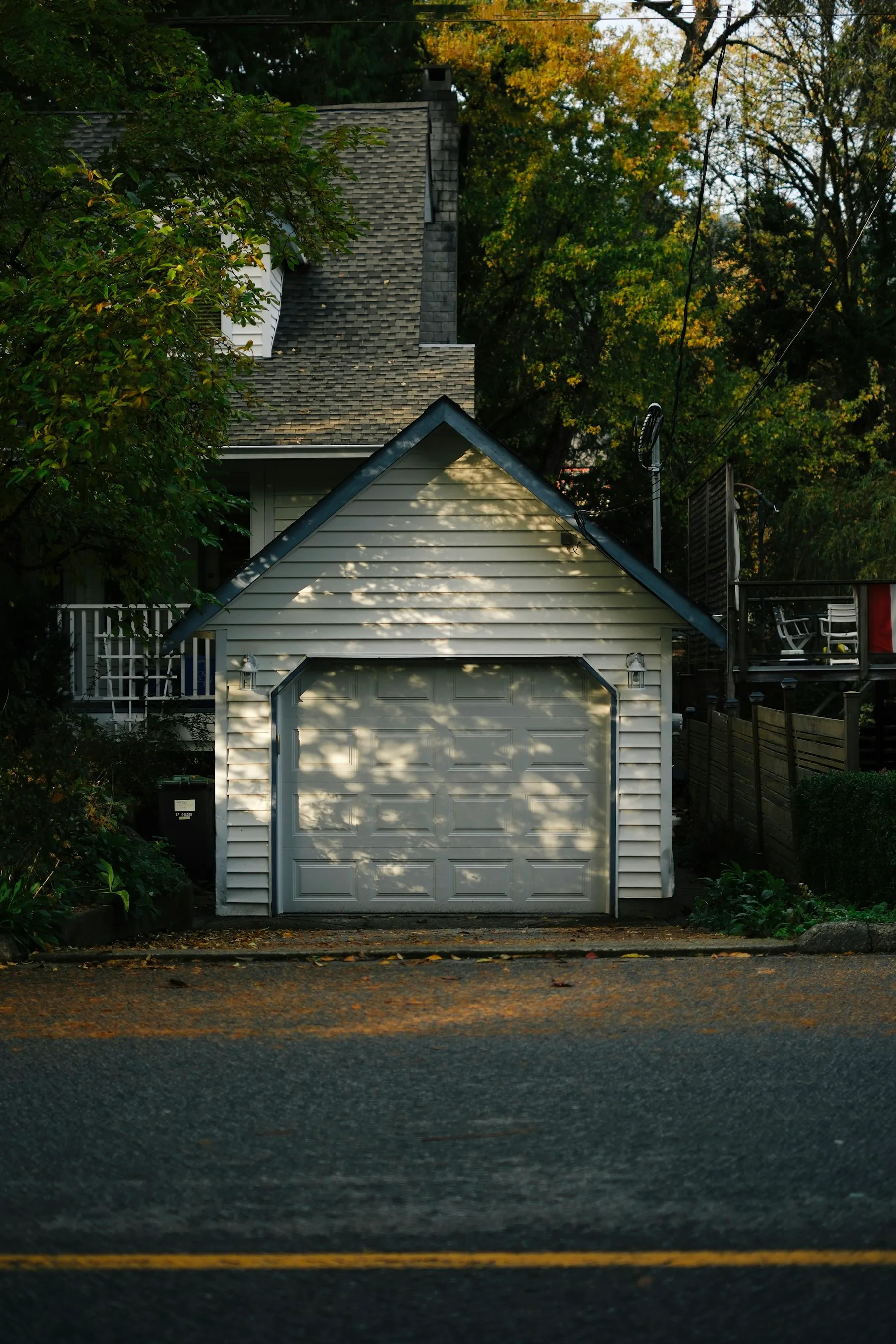 A small detached garage with a white carriage door