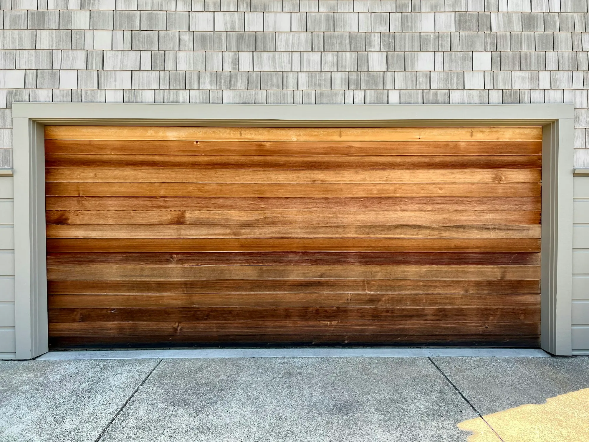 After: a new horizontal cedar-grain garage door